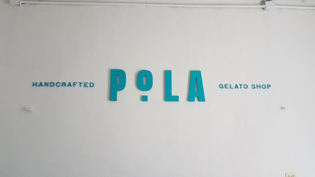 Pola, blue writing on white wall