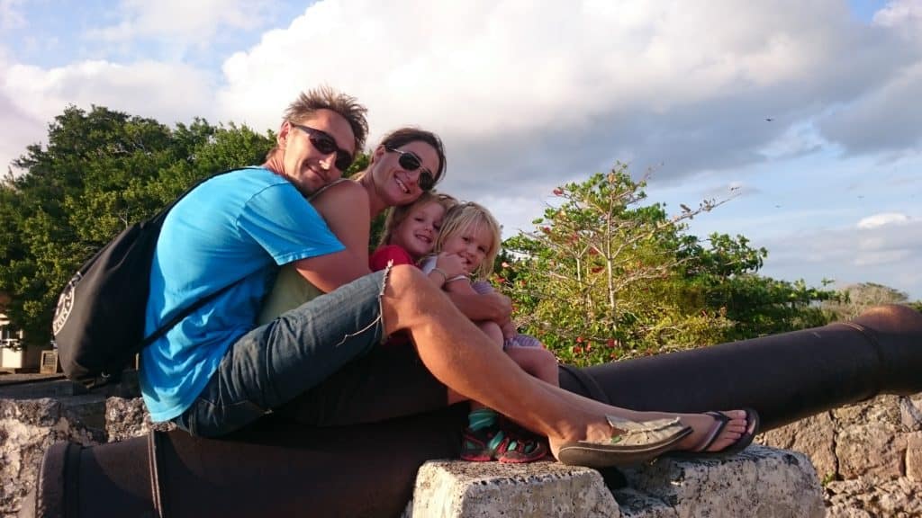Family (two parents and two tiny kids sitting on a cannon in Bacalar)