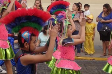 children in costume marching on the street