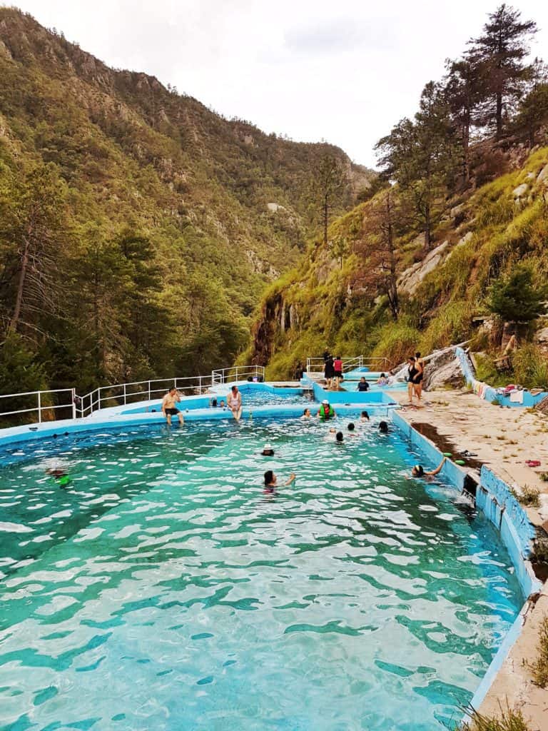 rekowata thermal pools, near Creel . view of pool with people in it, mountains surrounding