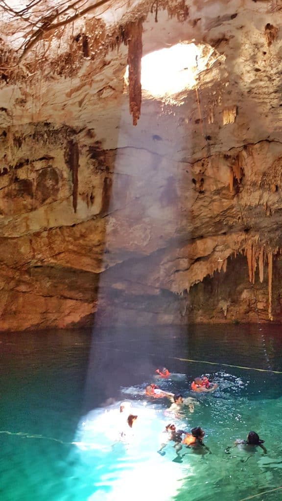 cenote with shaft of light beaming down