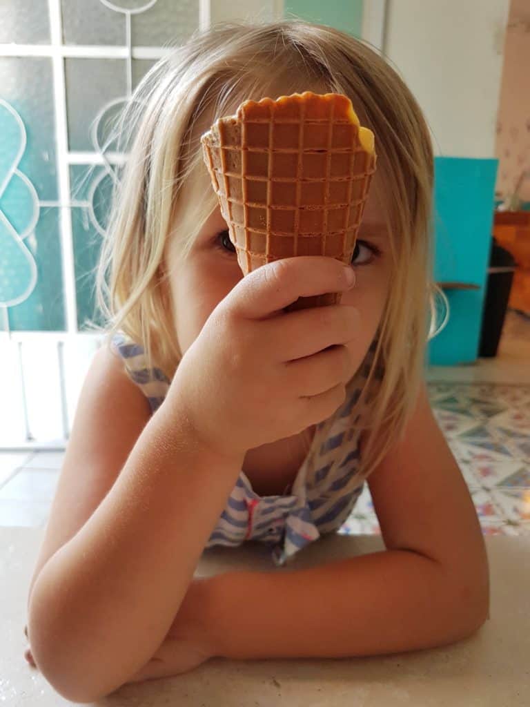 girl hiding behind ice cream cone