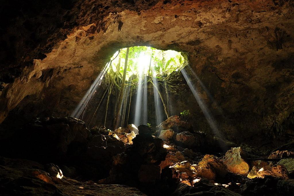 sunlight shining through entrance to cave