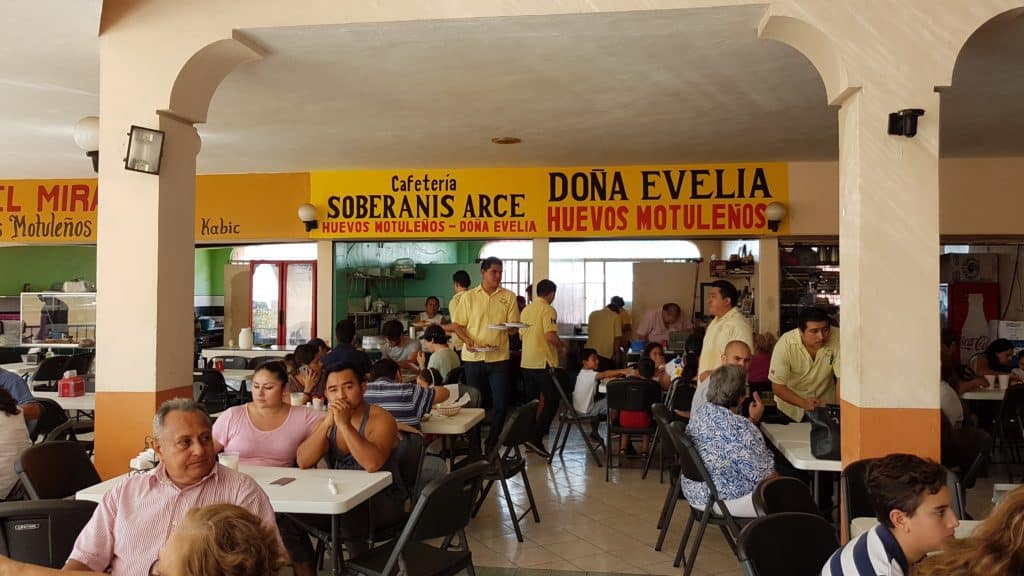indoor cafe. lots of people. Sign saying Doña Evelia