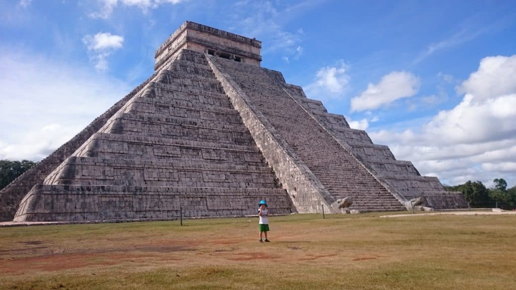 main pyramid from Chichen Itza with small child in front