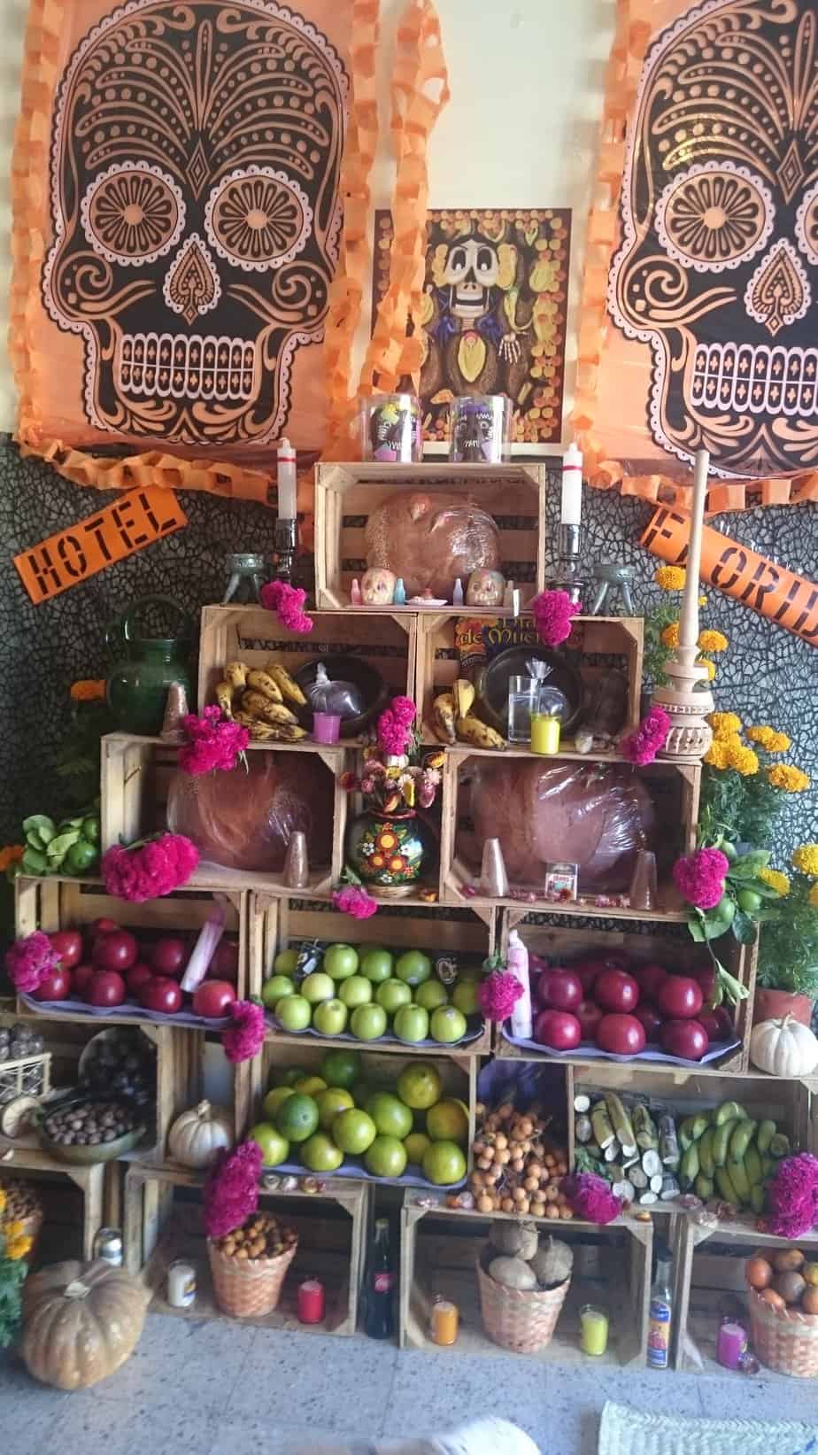 Ofrenda (altar) made of boxes for day of the dead. Lots of fruit and candles