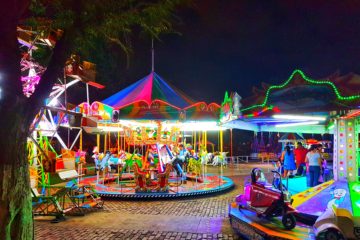 brightly lit fun fair in the dark