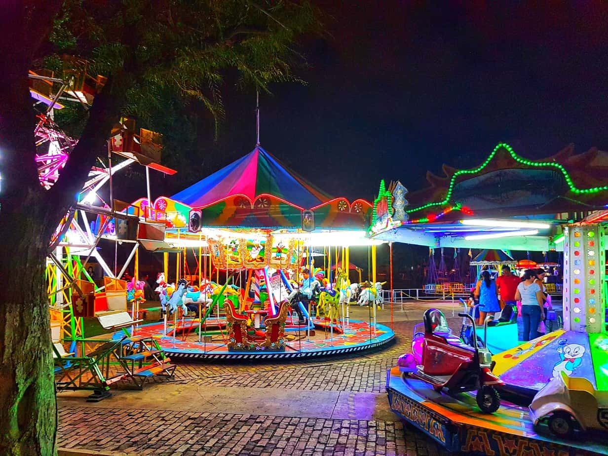 brightly lit fun fair in the dark