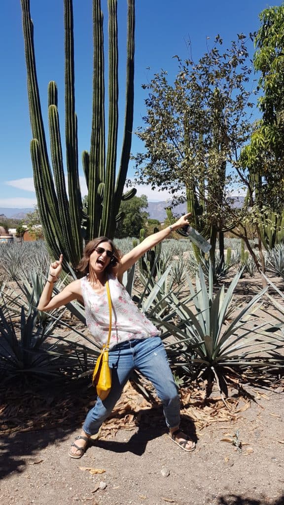 Cassie in a silly pose in front of a cactus