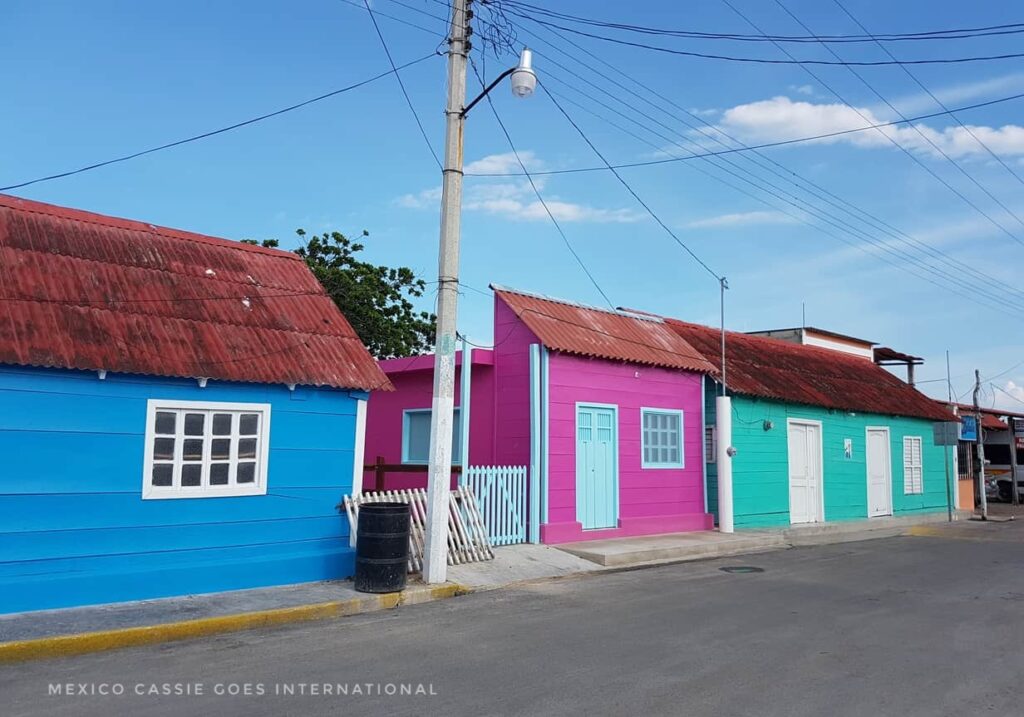 famous wooden houses of san felipe, yucatan. three in a row: blue, pink green