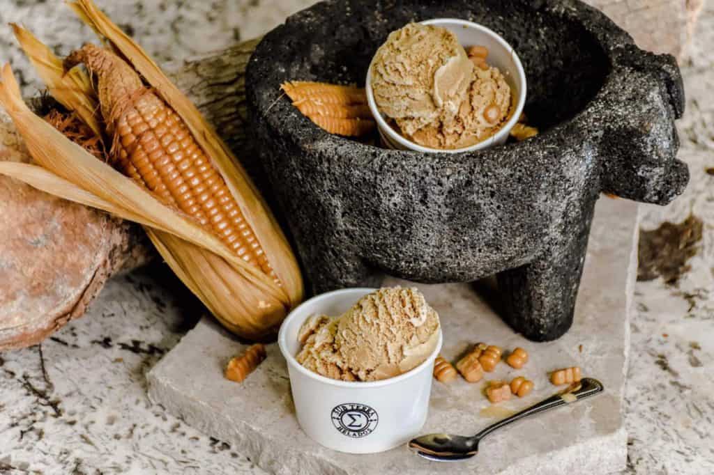 ice cream with corn and a molcajete, posed artistically