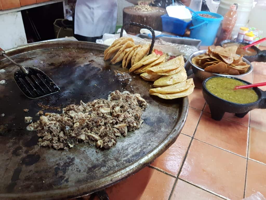 comal with tacos and meat cooking