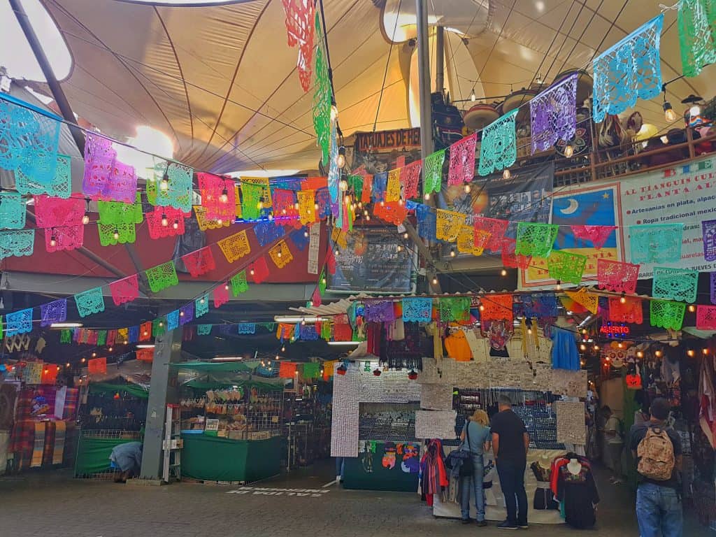 market entrance, Mexican colourful flags (paper cuts)
