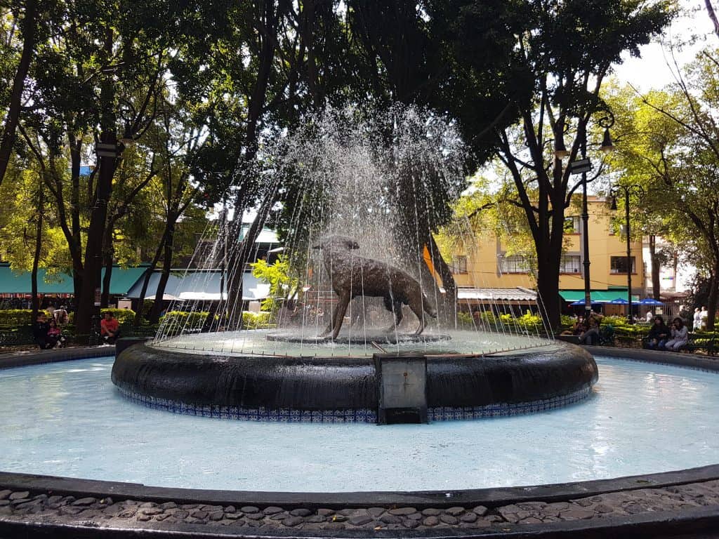 fountain with wolf statue in middle
