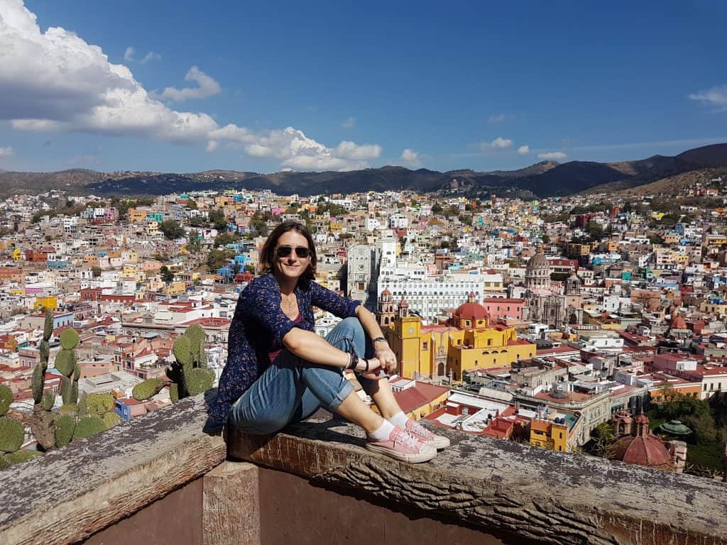 Mexico Cassie sitting on a corner wall overlooking the city of Guanajuato