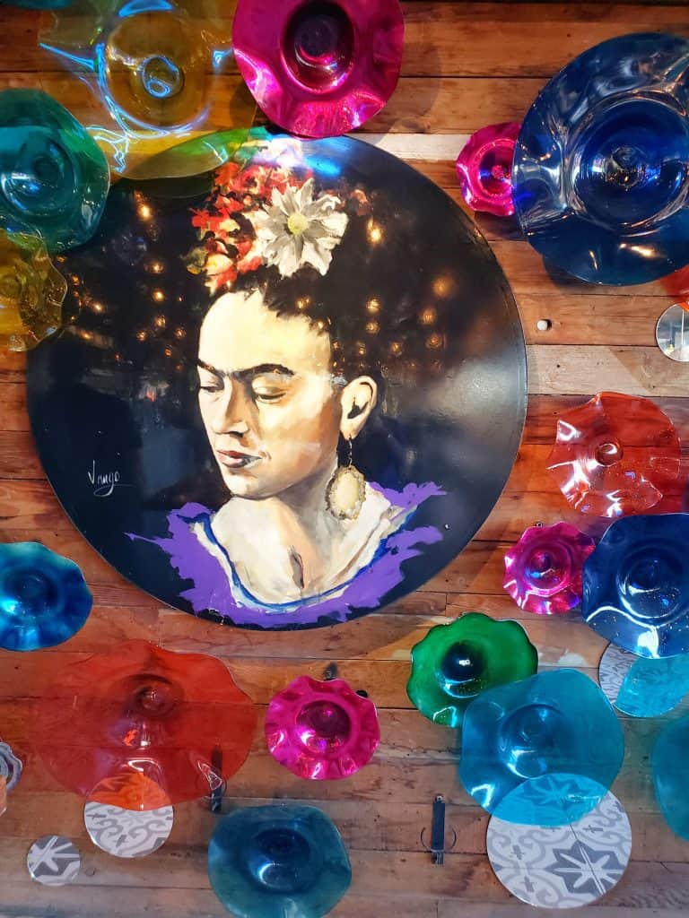 a wall decoration: Frida Kahlo with coloured glass plates around