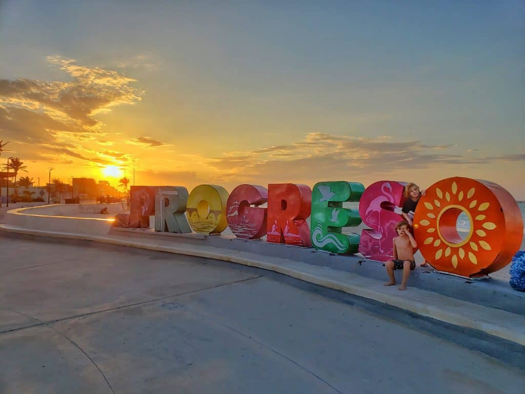Progreso letters from an angle with sunset behind