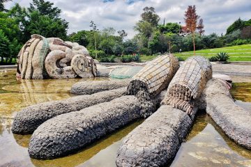 View of sculpture of Tlaloc (Mex rain god) in a pond.
