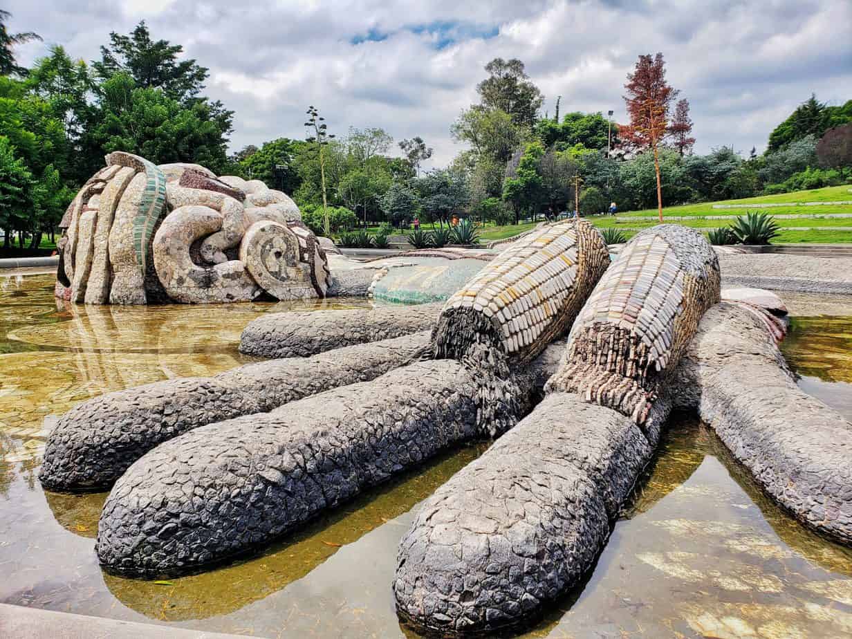 View of sculpture of Tlaloc (Mex rain god) in a pond.
