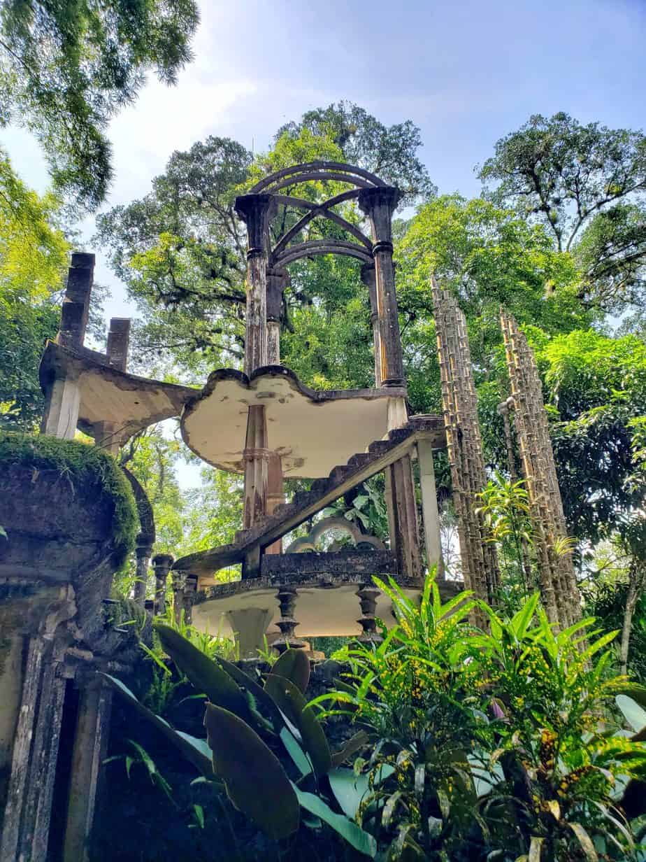 Las Pozas. Strange column structure surrounded by lush green trees
