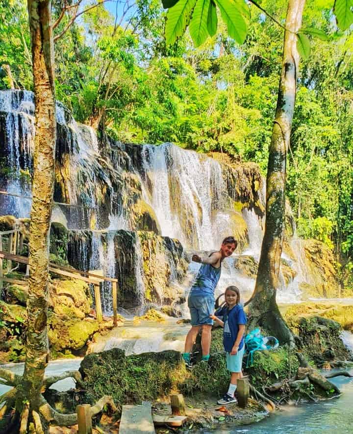 MexicoCassie and child standing in front of small waterfall