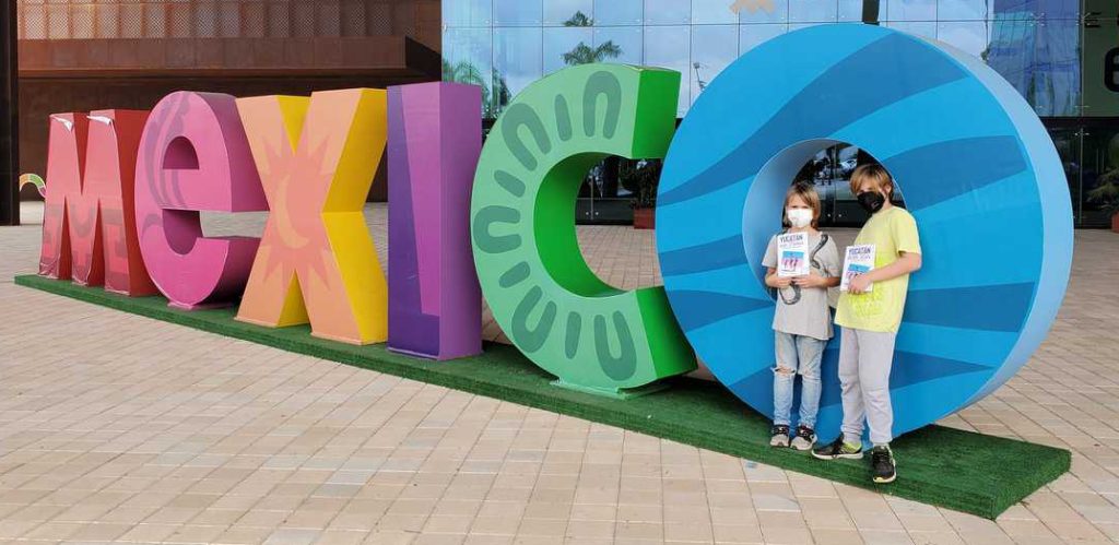 Mexico letters brightly coloured. two kids by the 'o'