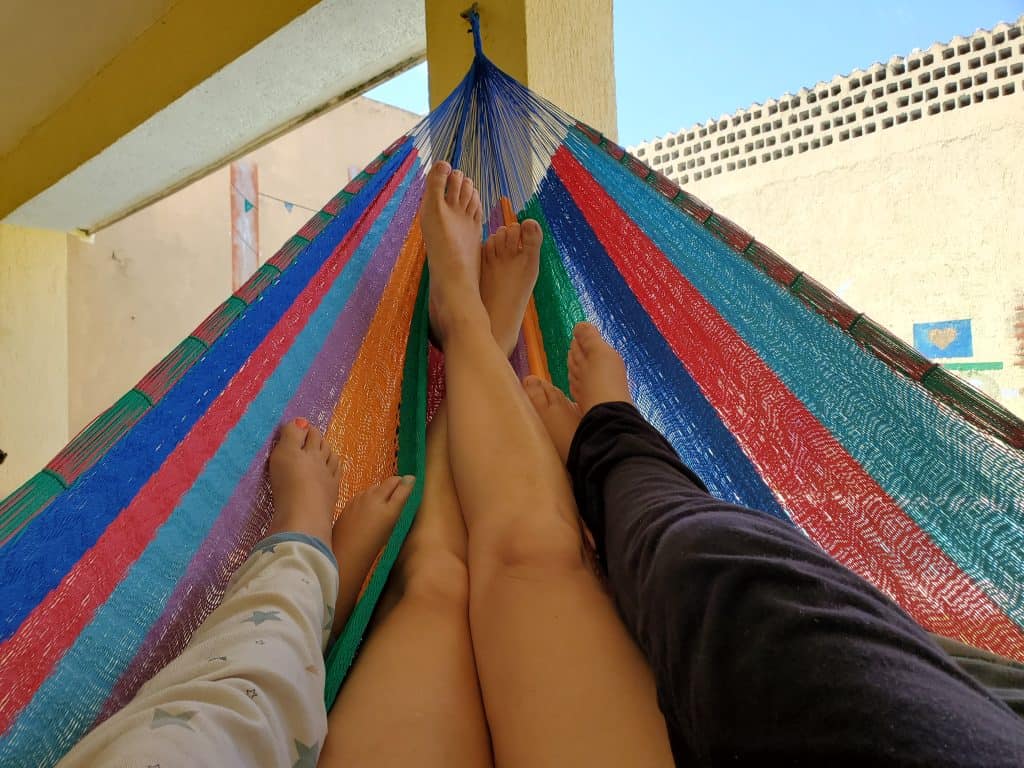 three pairs of legs in a hammock