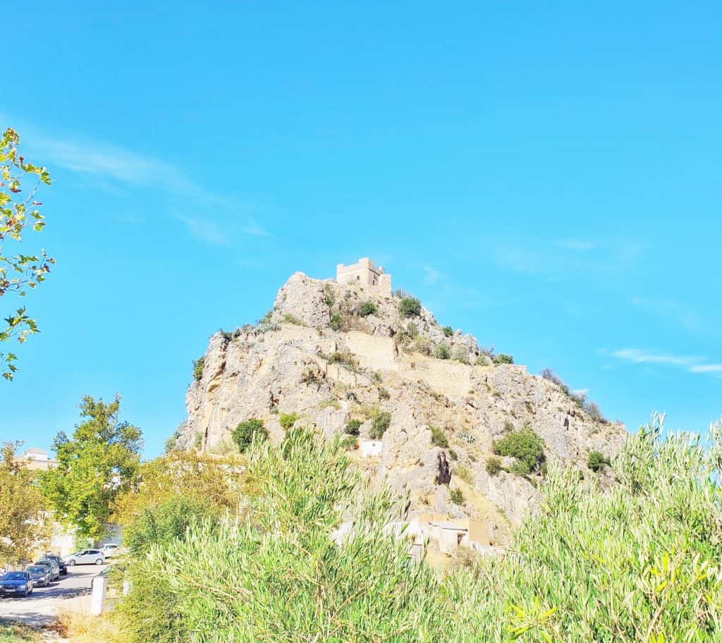 castle on top of a rocky outcrop, bright blue skies