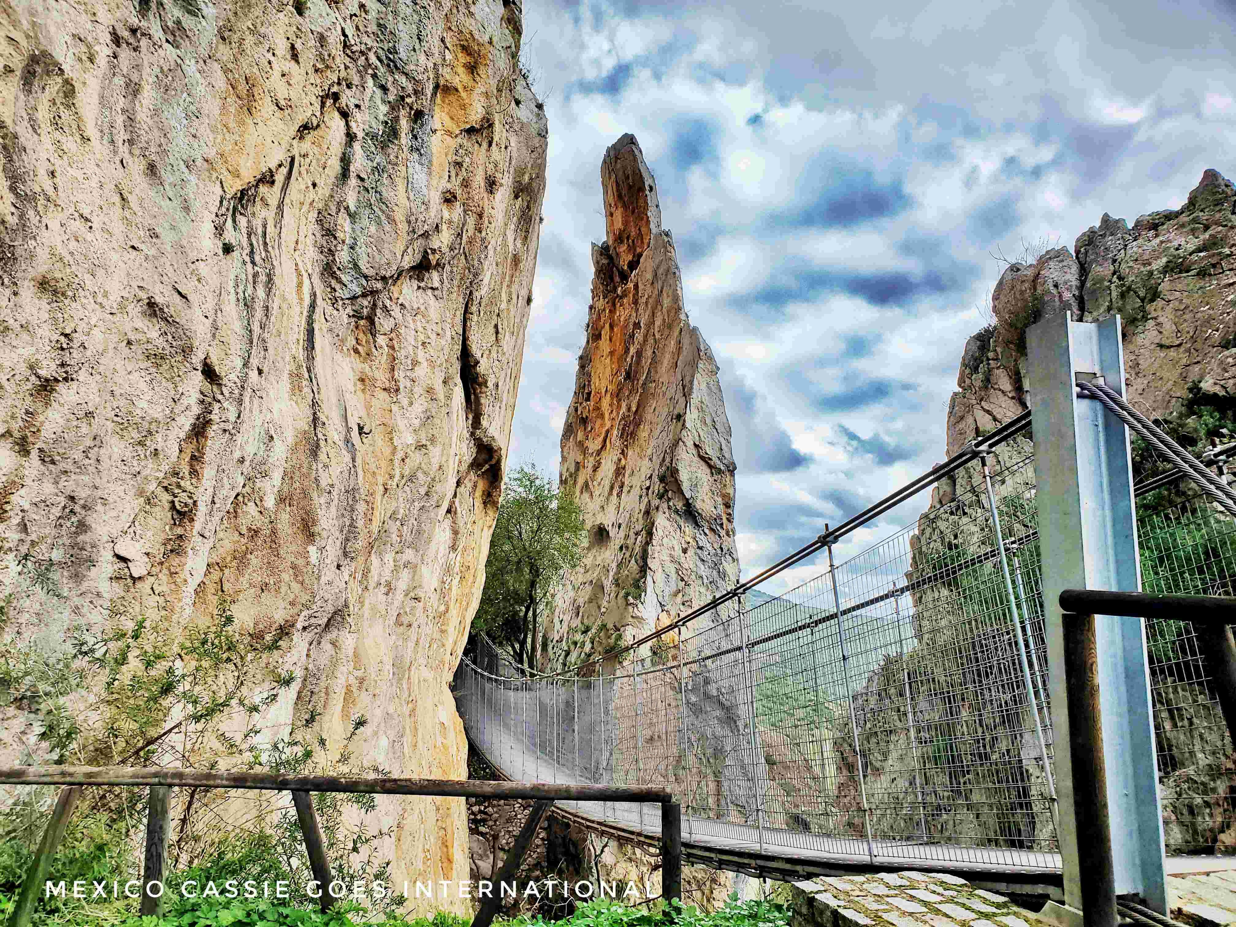 short metal hanging bridge between two rocks
