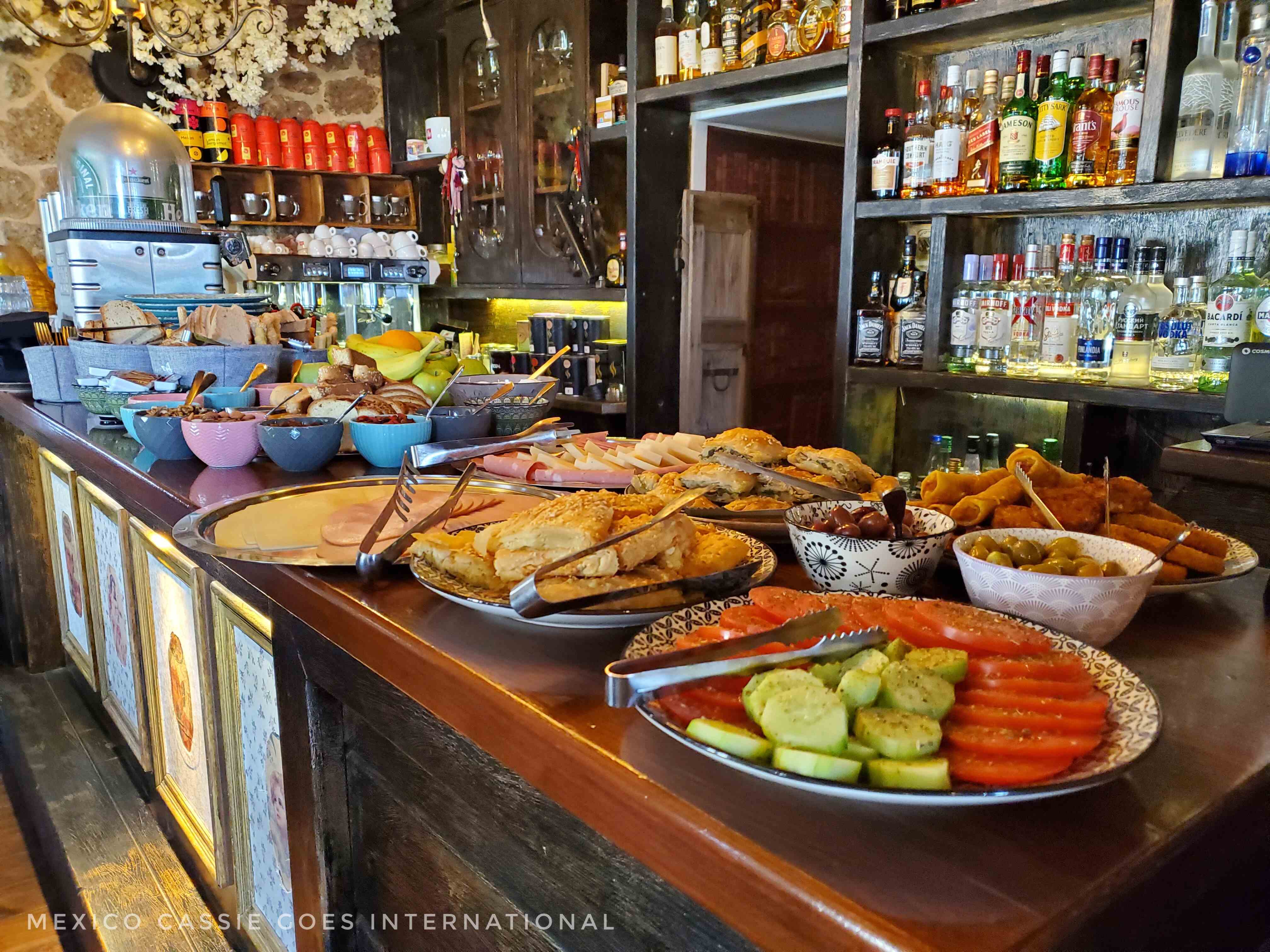 view down a bar covered in plates of food