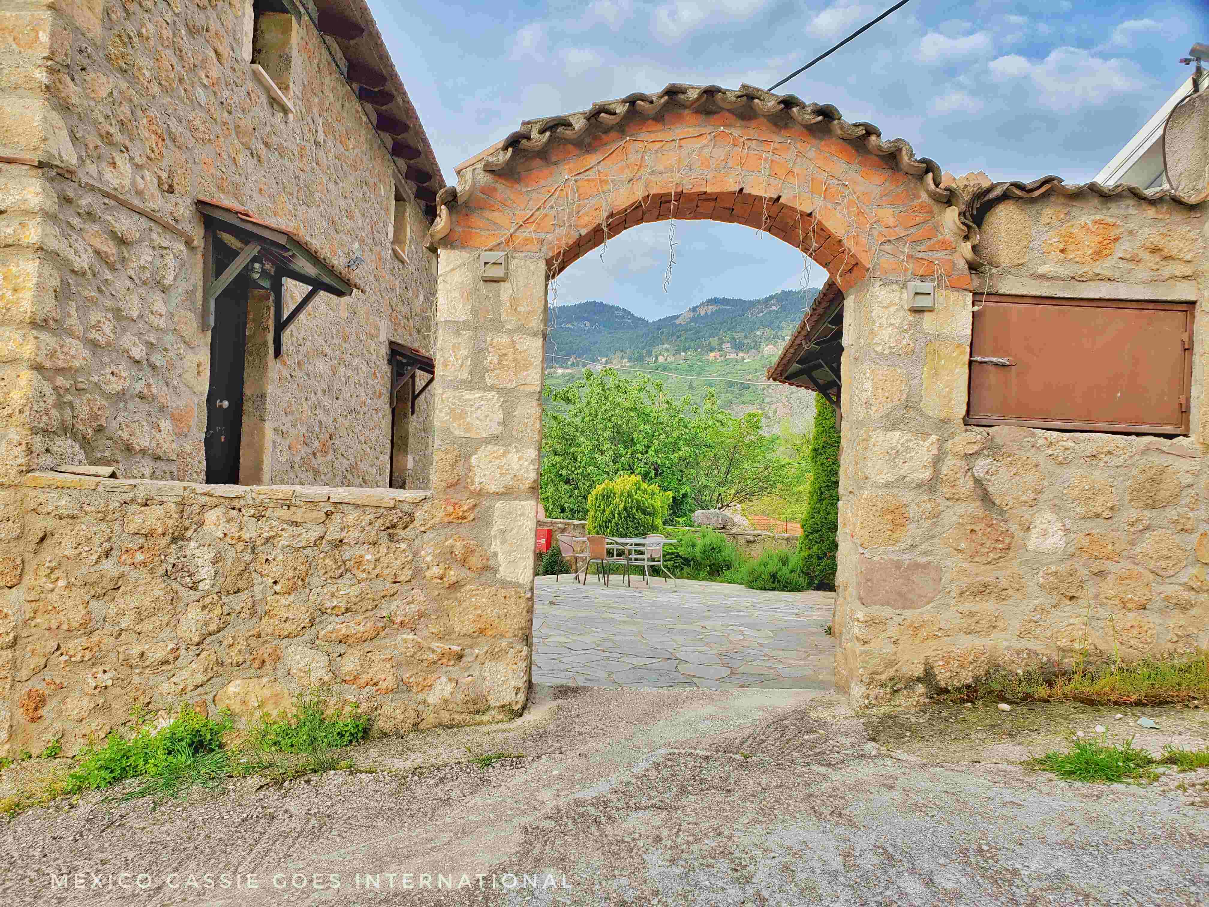 view through archway -mountains and greenery in background
