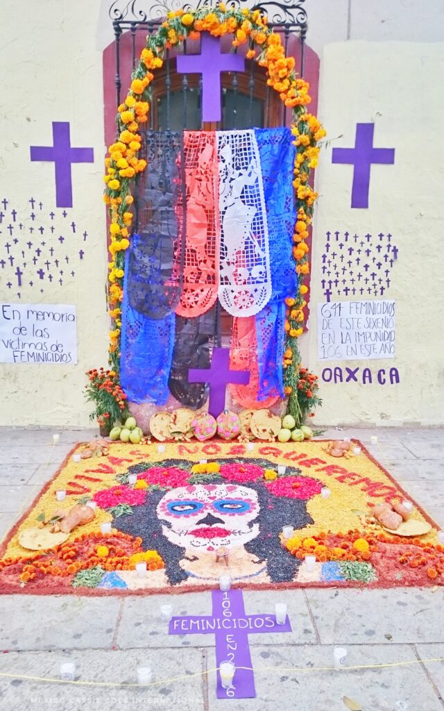 tapete de arena (sand carpet) in Oaxaca dedicated to the women killed by men that year- Shows a woman with her face paint and red flowers in her hair