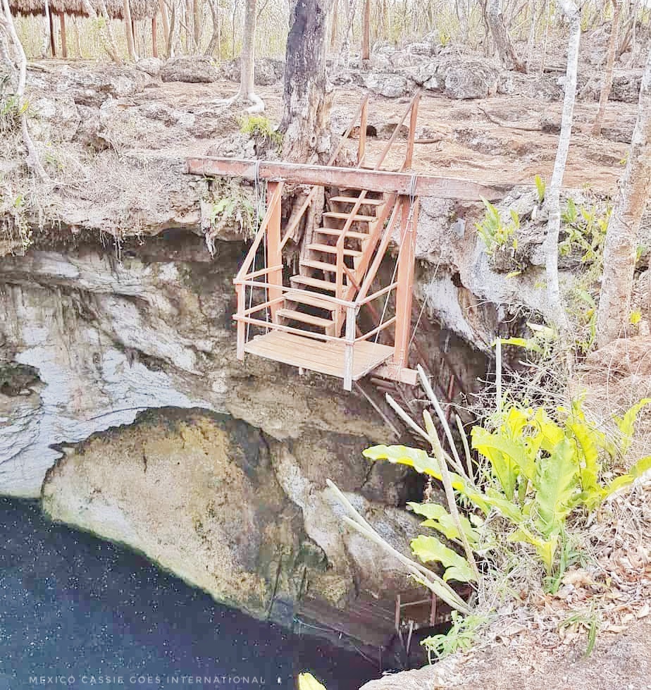 wooden staircase on side of cenote