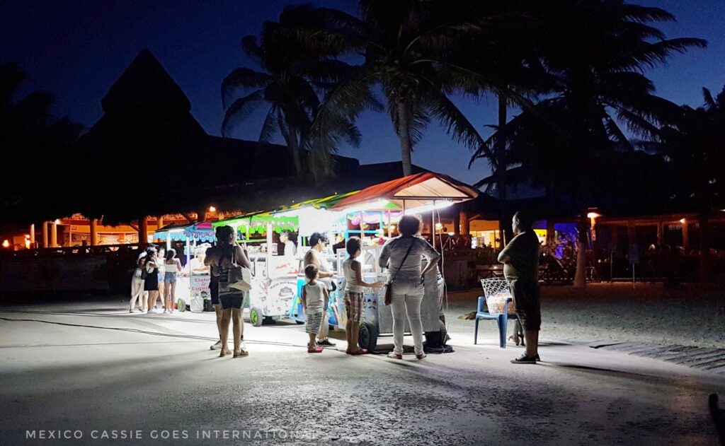 night scene of people at street food stalls