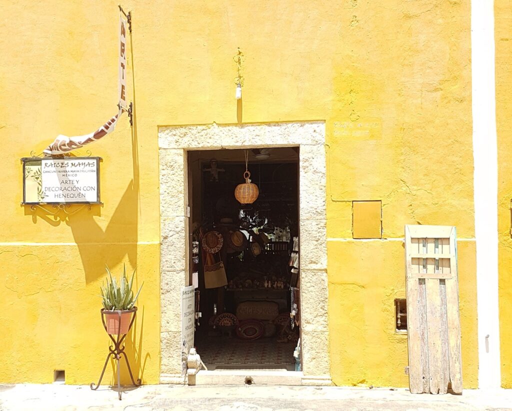 yellow wall, open door to shop