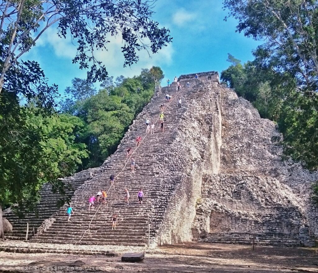 large pyramid with people climbing it