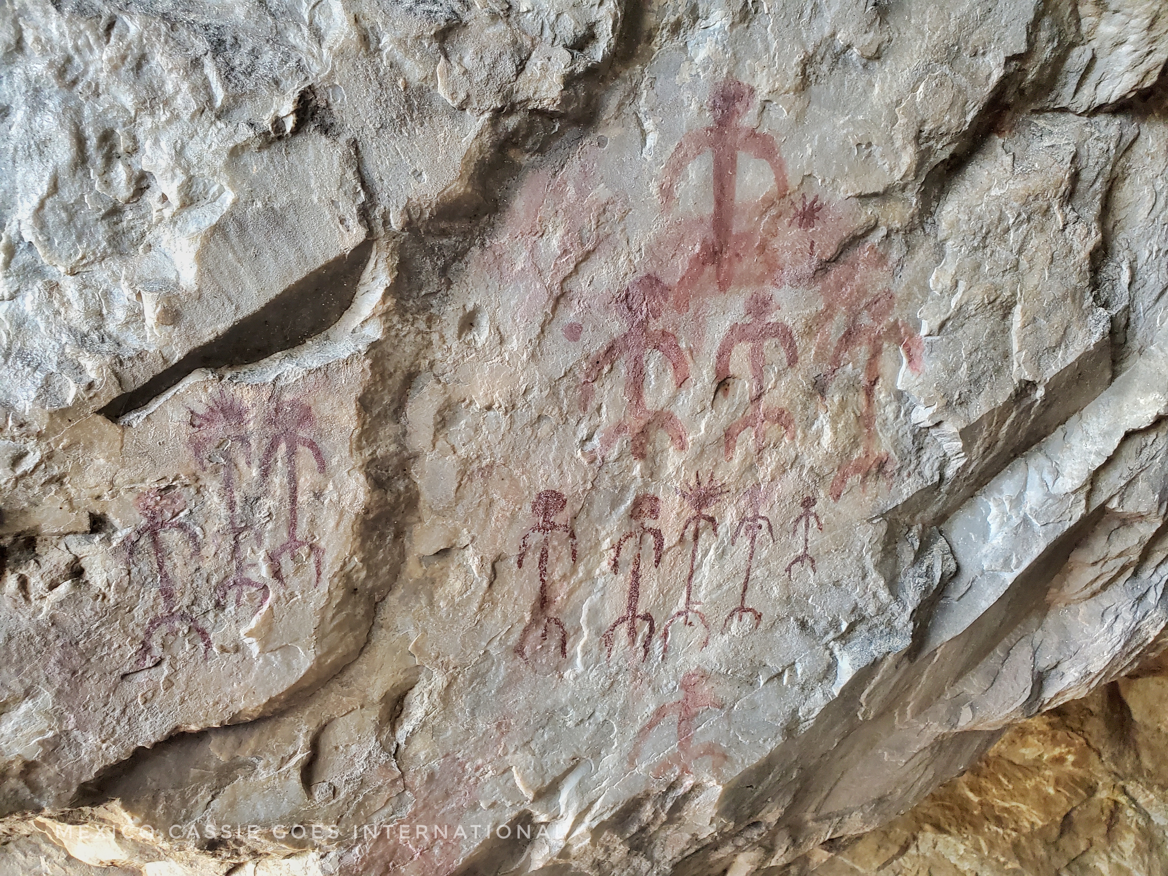 rock art: ancient paintings of figures painted in red on rock