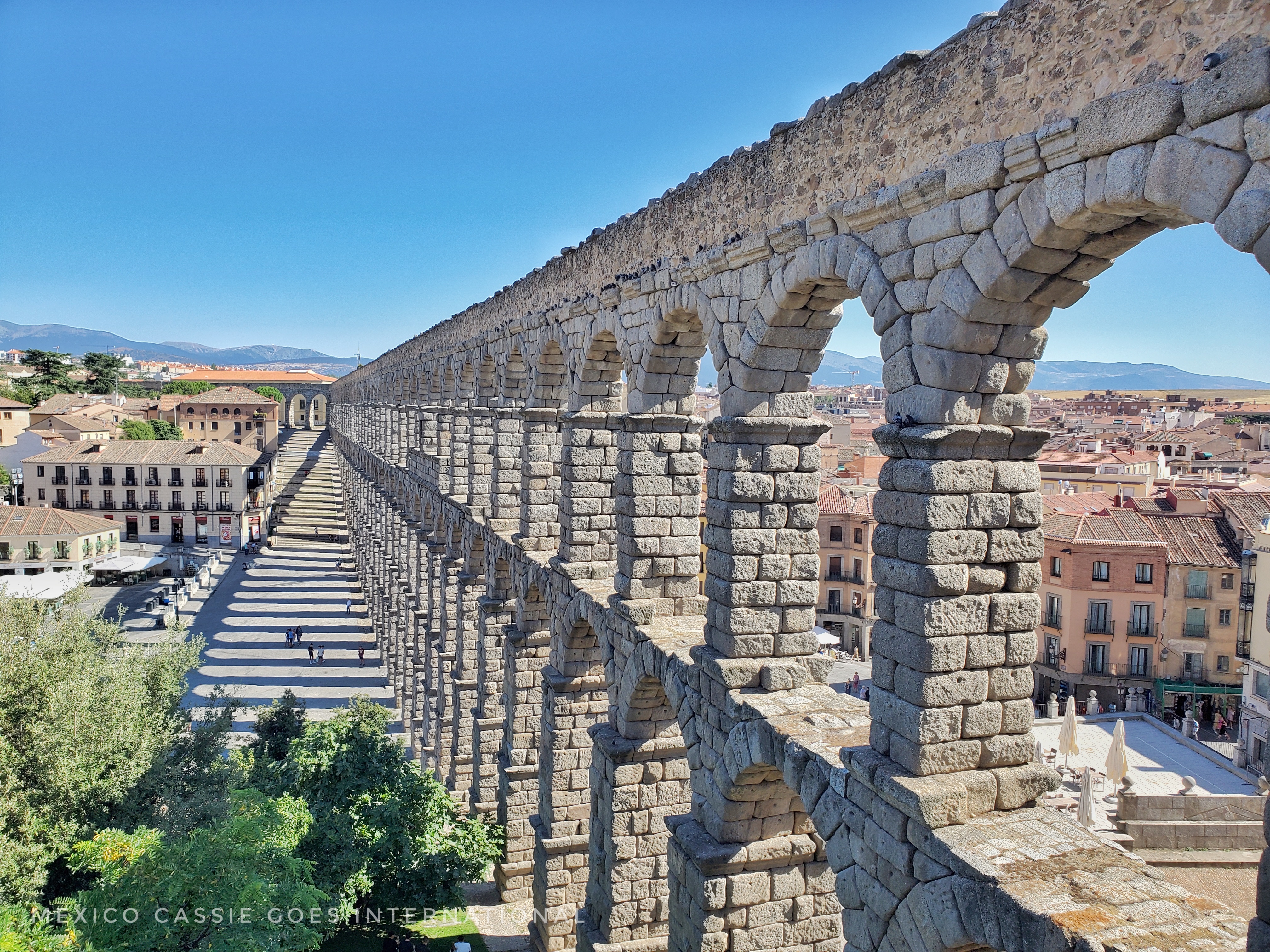 double arched aqueduct running into distance, great shadow on ground