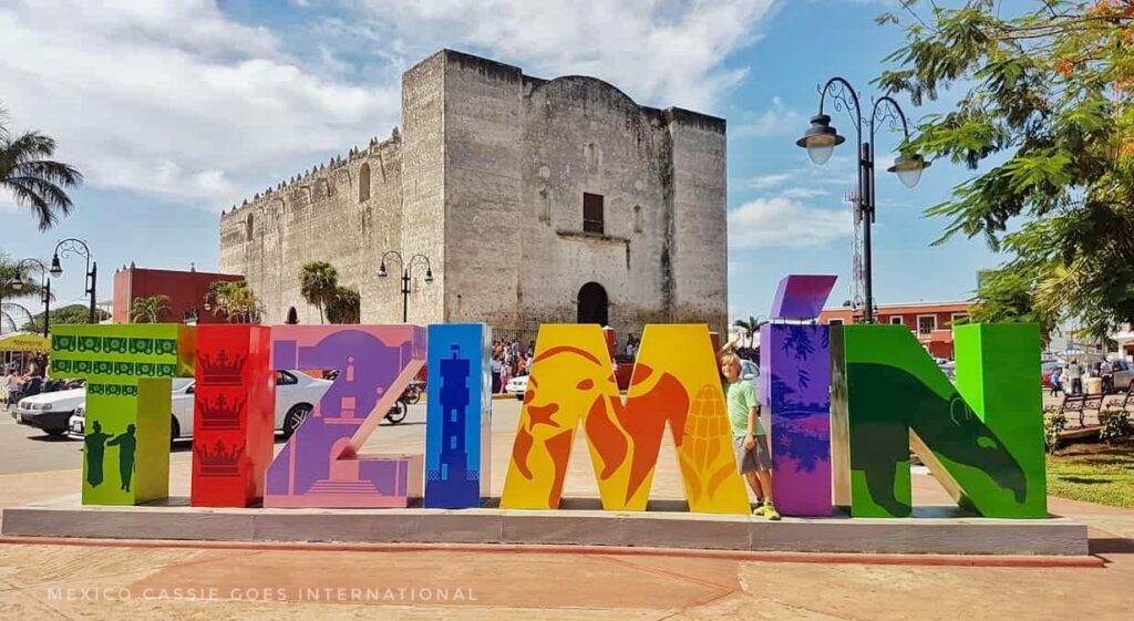 large colourful letters - TIZIMIN in front of a squareish church building