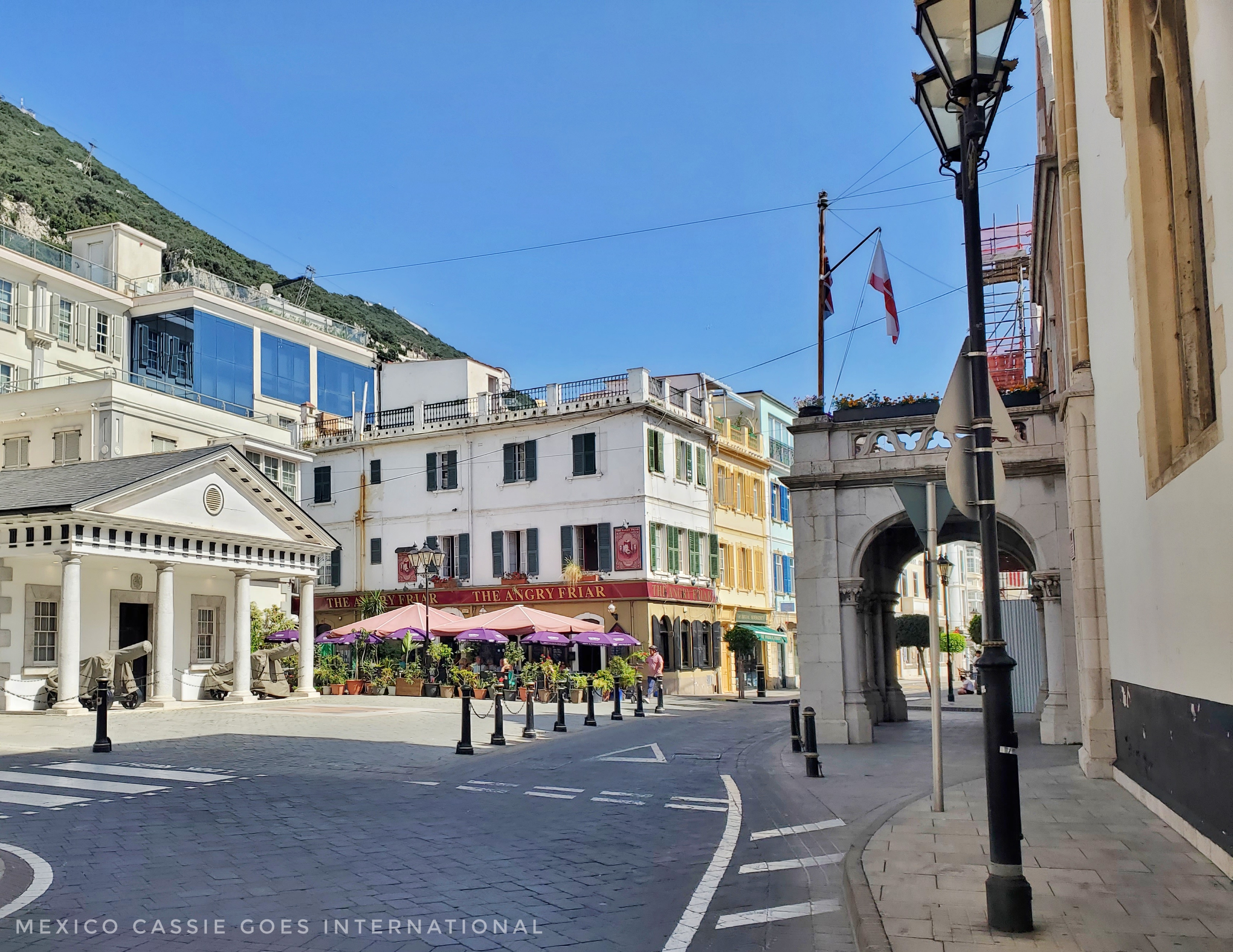 small plaza in gibraltar. white columned building on left