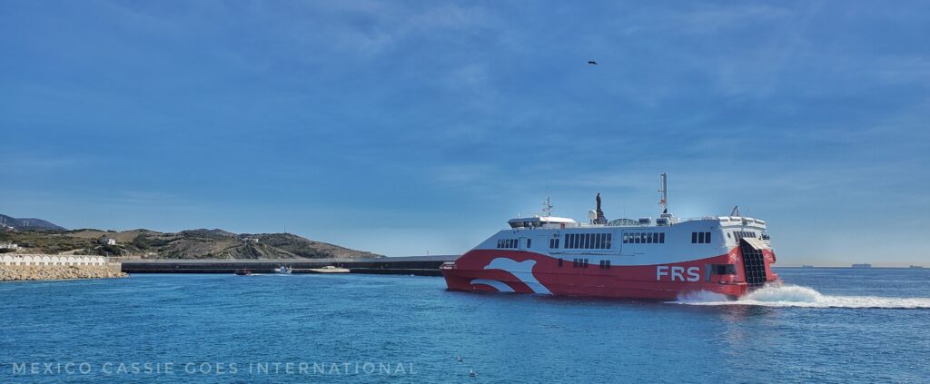 red and white FRS ferry sailing into port
