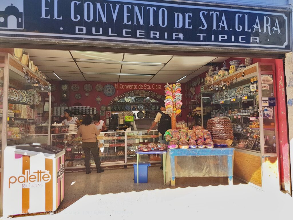 looking into a traditional candy store - blue sign above reads "El Convento de Sta Clara, Dulceria Tipica"