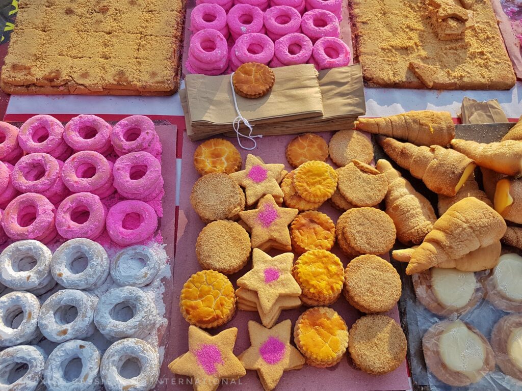 selection of yellow and pink cookies on a tray