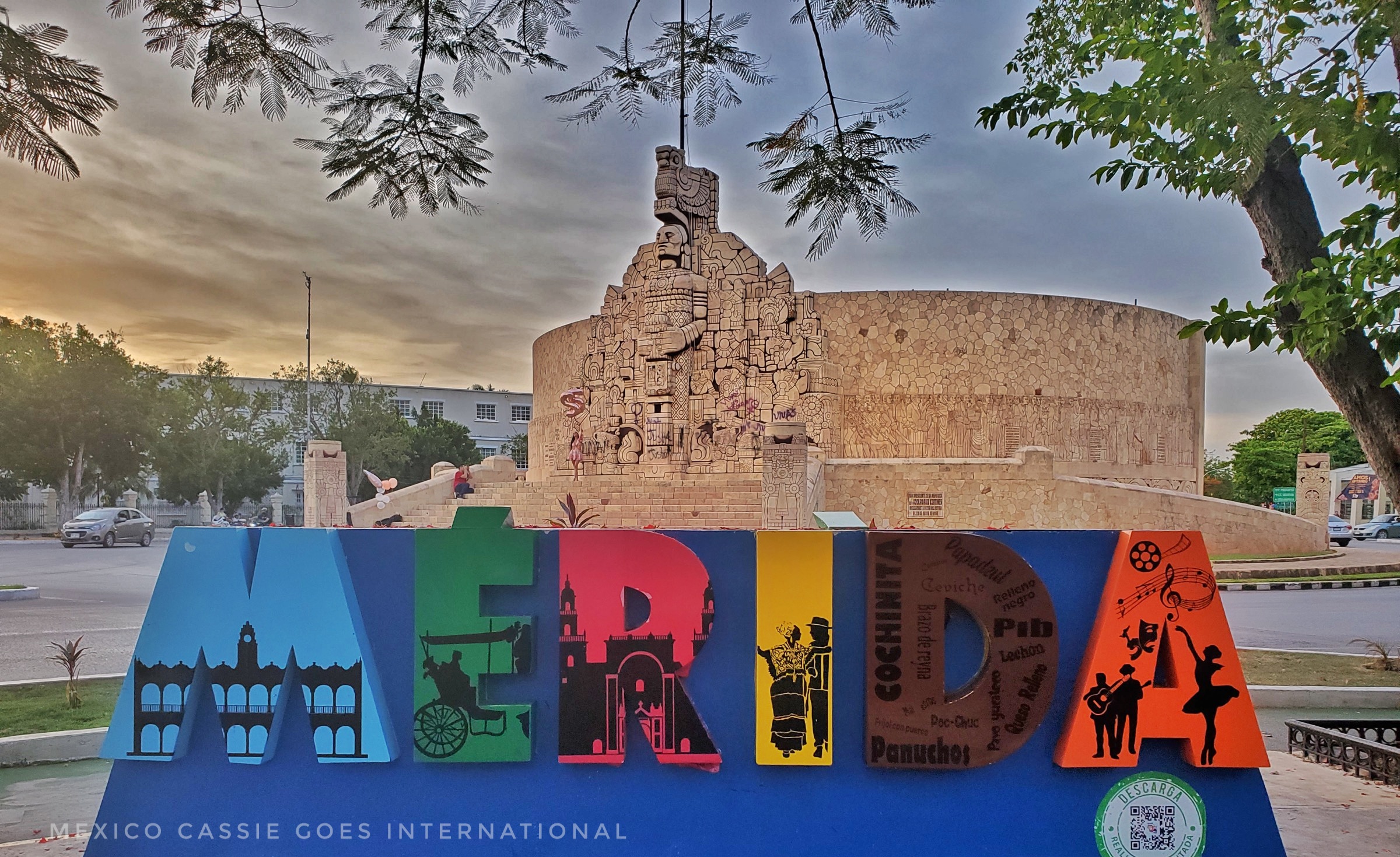 Colourful letters spelling MERIDA with monumento de la patria in the background