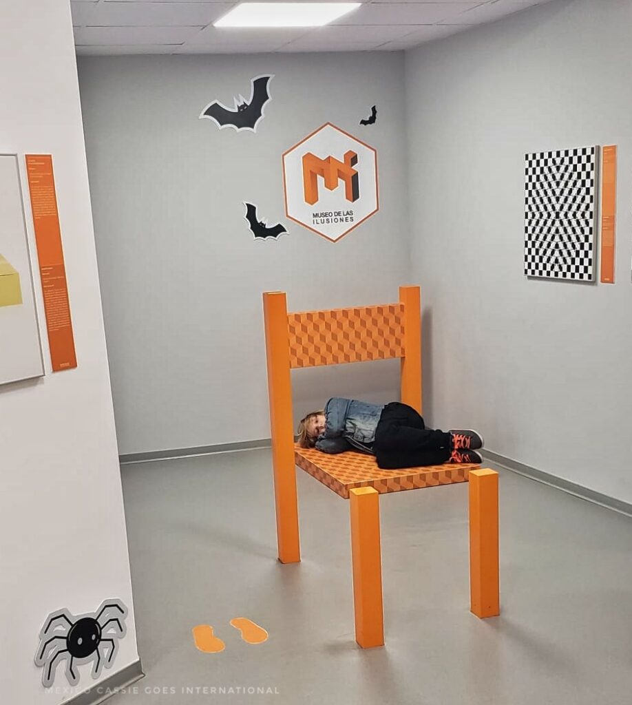 child lying on chair (except chair is an optical illusion)