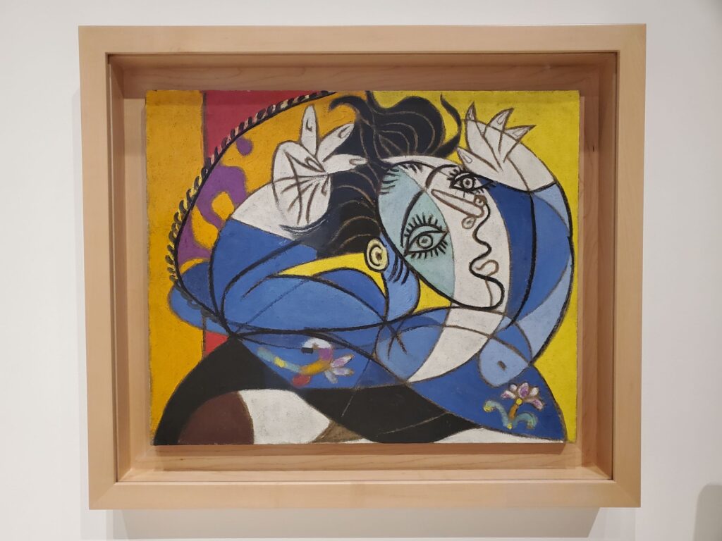 Picasso painting  - blue and white woman, black hair, yellow background