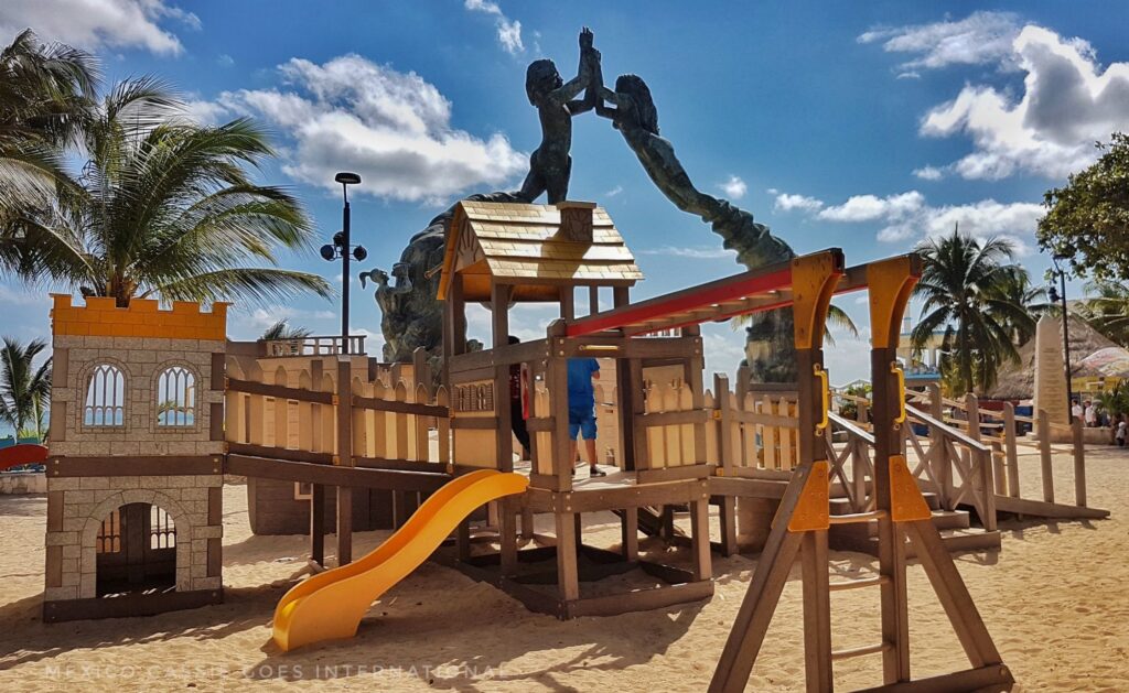 modern playground on the sand. 2 kids in it