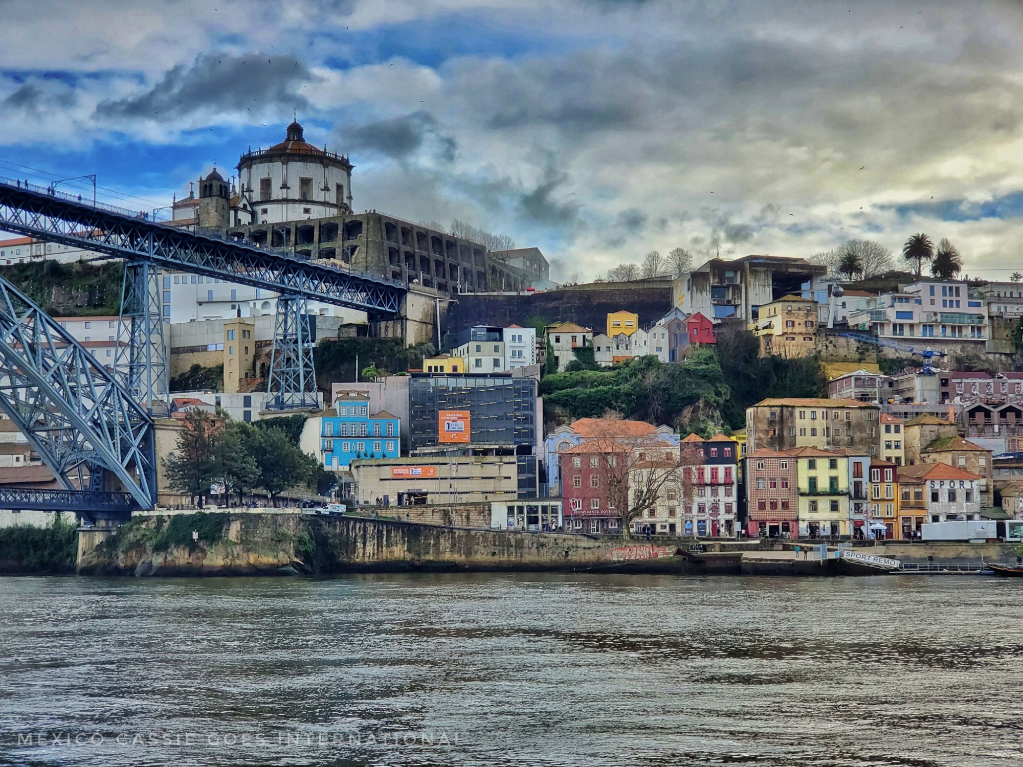 view of Gaia from Porto over the river- Edge of bridge visible on left side of screen. houses are all very colourful