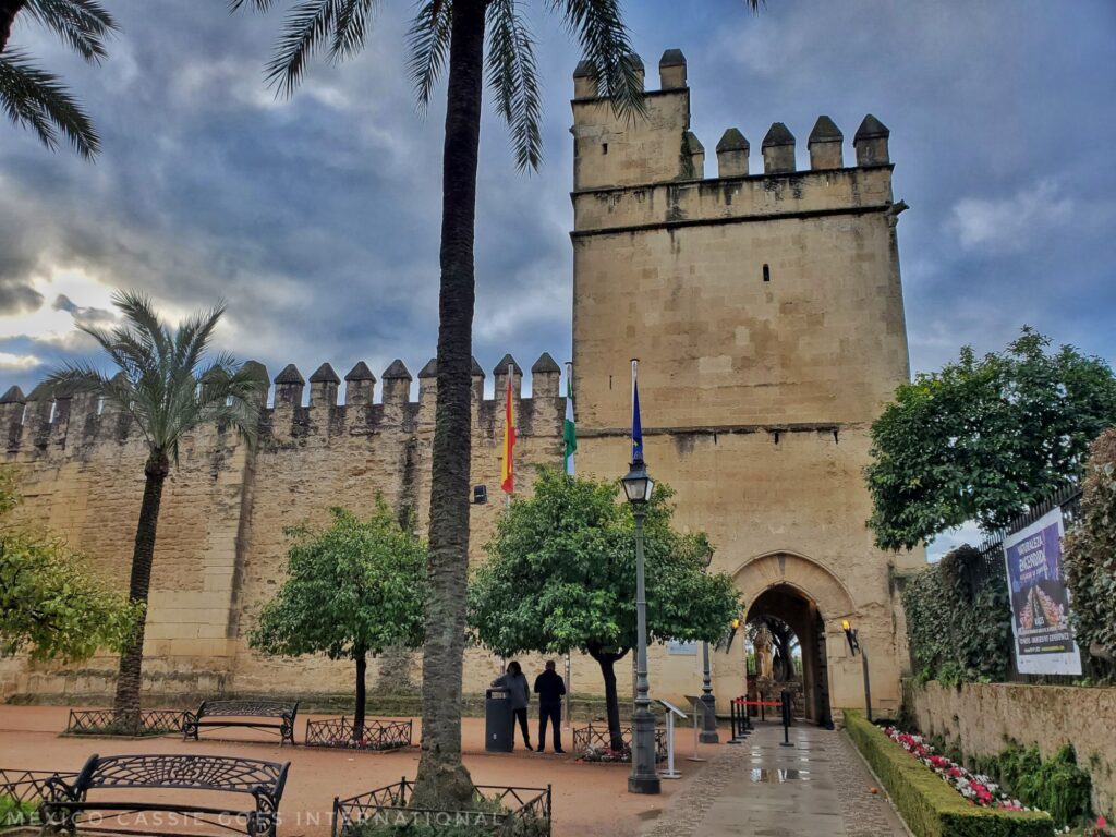 cordoba alcazar from outside - typical castle with turret and crenelations , people standing around