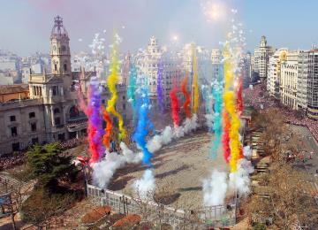 city plaza with brightly coloured smoke plums emanating